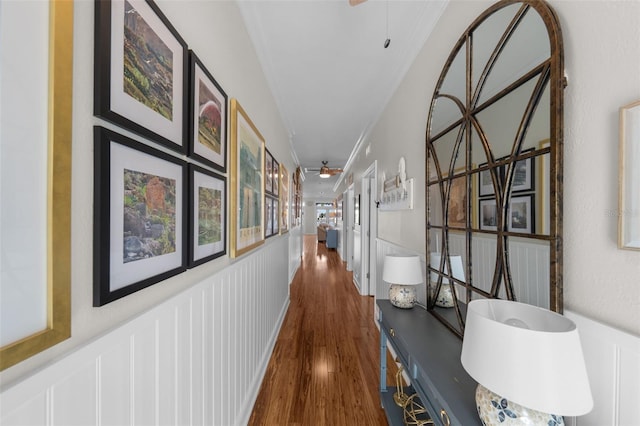 corridor with dark hardwood / wood-style flooring and crown molding