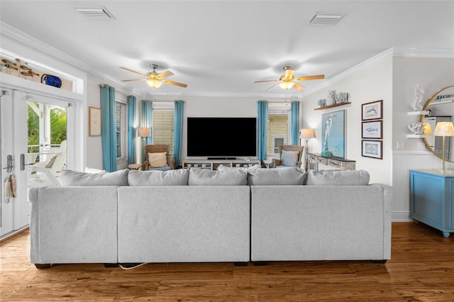 living room with crown molding, french doors, ceiling fan, and dark wood-type flooring