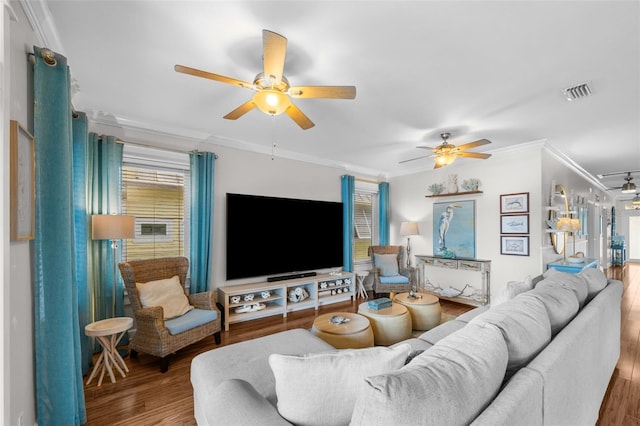 living room with hardwood / wood-style flooring, ceiling fan, and ornamental molding