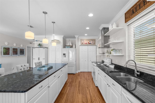 kitchen with white cabinetry, dark stone countertops, white appliances, and sink