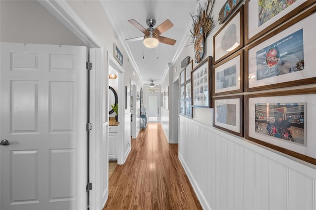 corridor featuring hardwood / wood-style flooring and ornamental molding