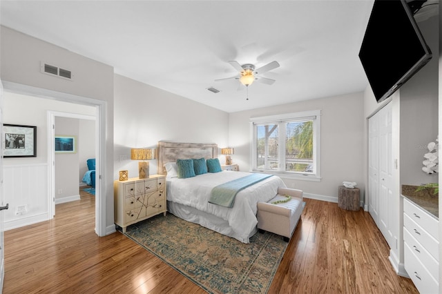 bedroom featuring ceiling fan, wood-type flooring, and a closet