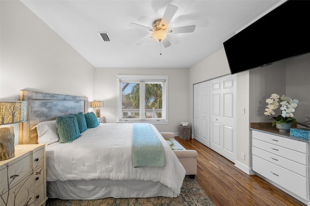 bedroom with ceiling fan, dark hardwood / wood-style floors, and a closet