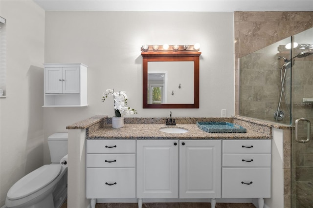 bathroom with vanity, toilet, and walk in shower