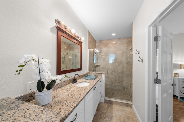 bathroom featuring vanity and an enclosed shower