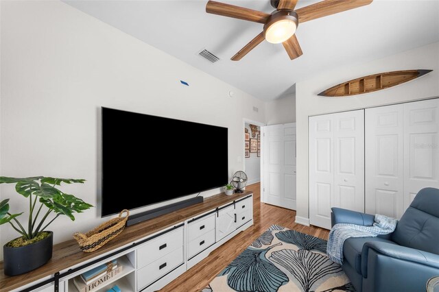 living room featuring hardwood / wood-style floors and ceiling fan