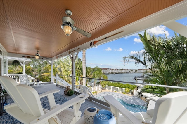 view of patio with ceiling fan and a water view