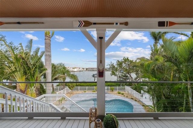 exterior space with a fenced in pool and a water view