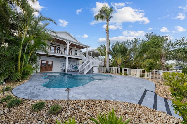 view of swimming pool featuring a patio area and a jacuzzi