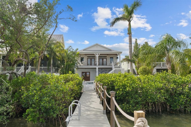 rear view of property with a water view and a balcony