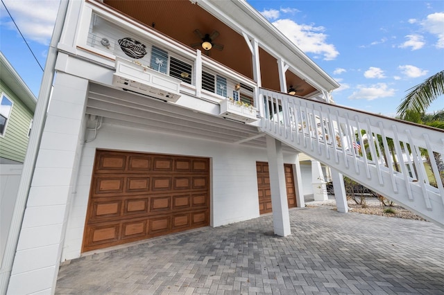 view of front of property with a garage and a balcony