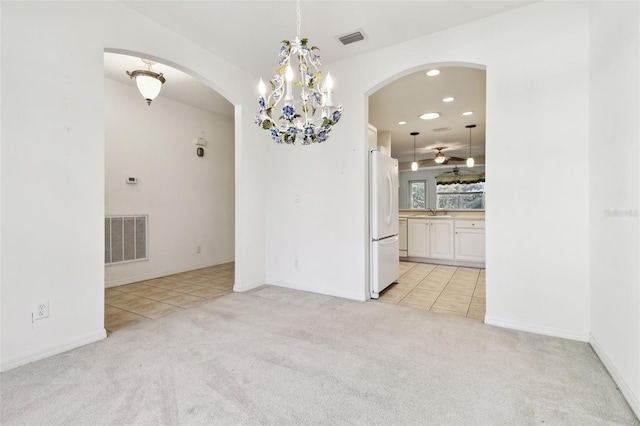 unfurnished dining area featuring light tile patterned floors, ceiling fan, and sink