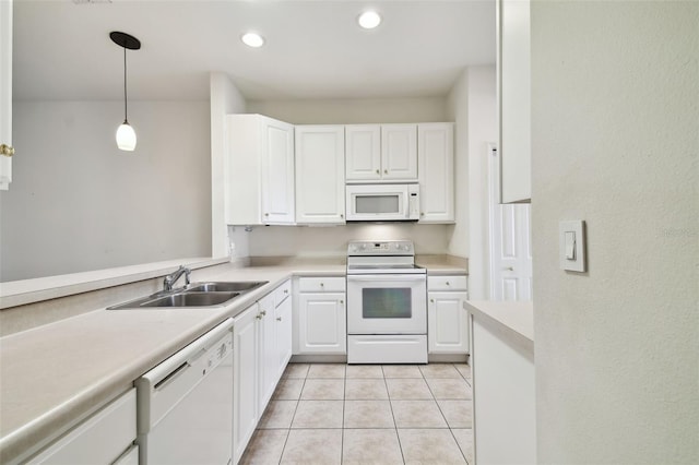 kitchen featuring white appliances, sink, light tile patterned floors, decorative light fixtures, and white cabinetry