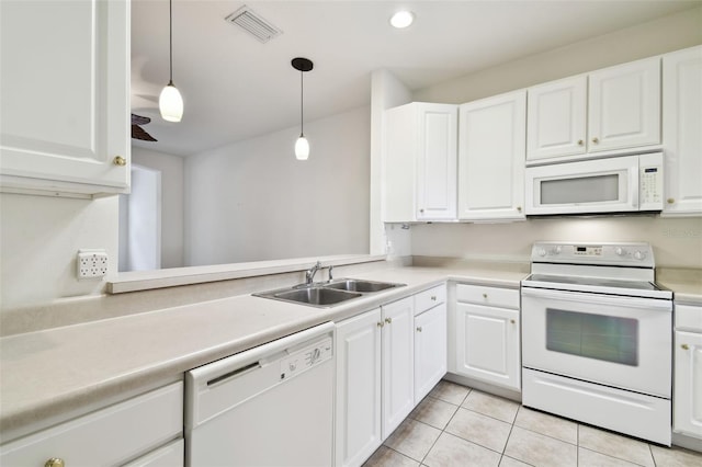 kitchen featuring white appliances, sink, pendant lighting, white cabinetry, and light tile patterned flooring