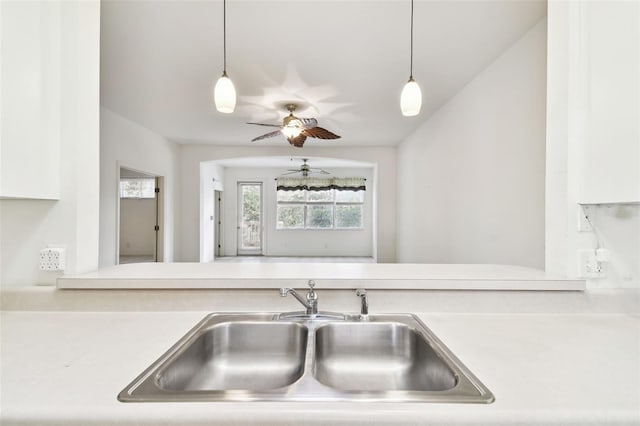 kitchen with ceiling fan, sink, and decorative light fixtures