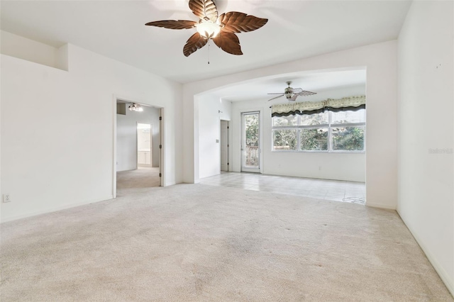 spare room with light colored carpet and ceiling fan