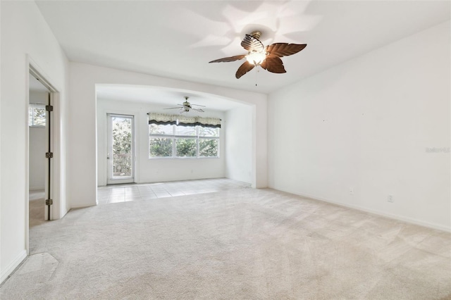 spare room featuring ceiling fan and light colored carpet