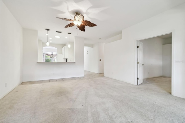 unfurnished living room with ceiling fan and light carpet