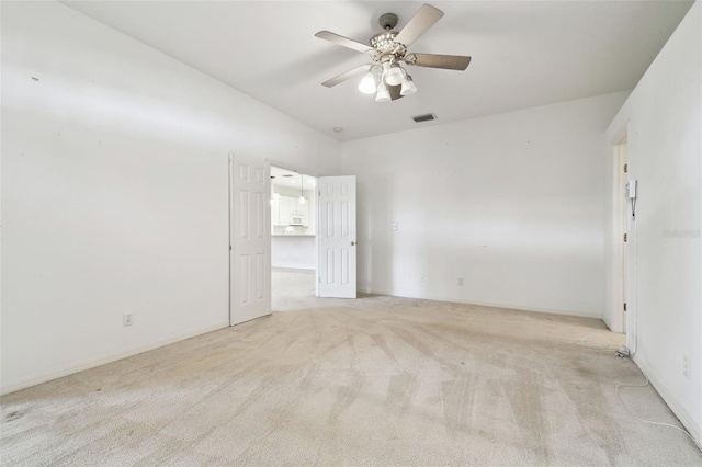 unfurnished room featuring light carpet and ceiling fan