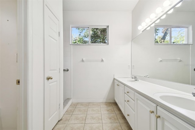 bathroom with plenty of natural light, vanity, and tile patterned flooring