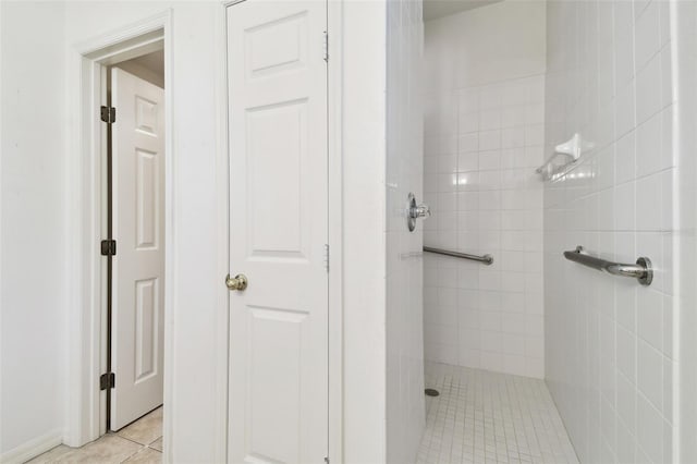 bathroom featuring tiled shower and tile patterned floors