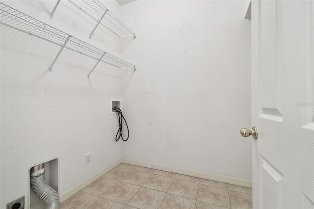 laundry room featuring light tile patterned flooring and washer hookup