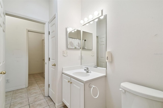 bathroom featuring tile patterned floors, vanity, and toilet