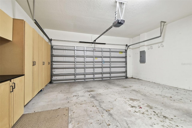 garage featuring electric panel and a garage door opener