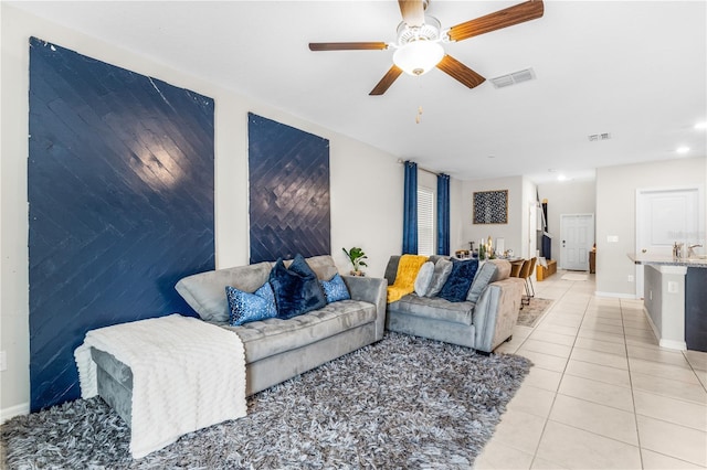 tiled living room with ceiling fan