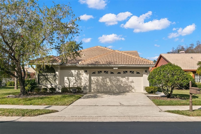 mediterranean / spanish house with a front yard and a garage