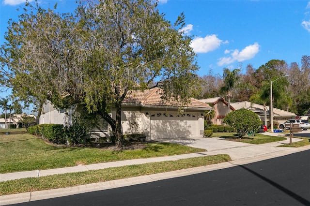 view of front of property with a front yard and a garage