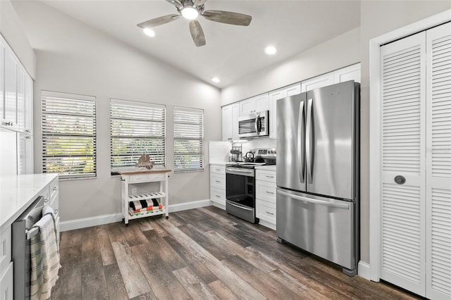 kitchen featuring white cabinetry, ceiling fan, stainless steel appliances, light stone counters, and lofted ceiling