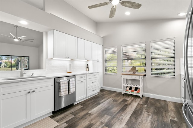 kitchen featuring tasteful backsplash, stainless steel dishwasher, sink, white cabinetry, and lofted ceiling