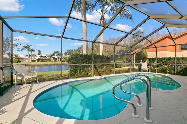 view of pool featuring a patio, a water view, and glass enclosure