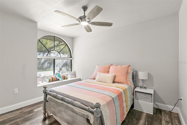 bedroom with ceiling fan and dark hardwood / wood-style flooring