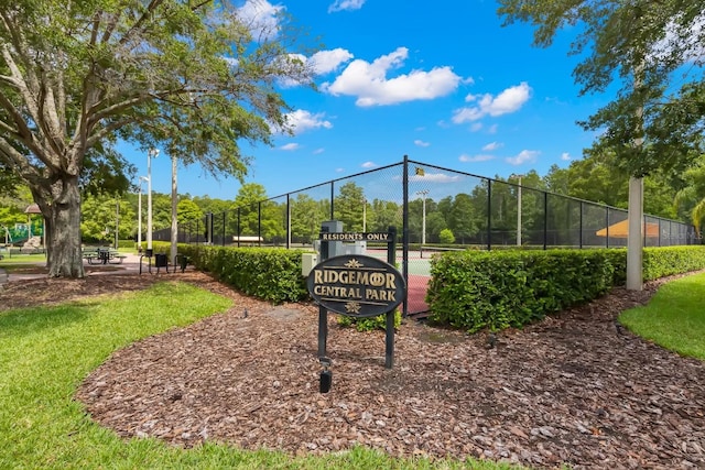 view of property's community featuring tennis court