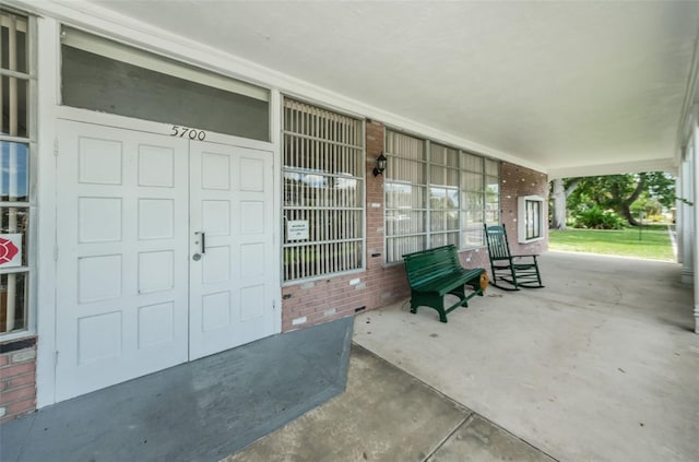 view of exterior entry with a porch