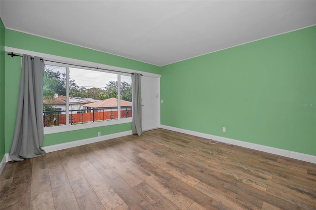 unfurnished room featuring hardwood / wood-style floors