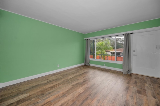 spare room with hardwood / wood-style flooring