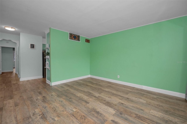 unfurnished room with wood-type flooring