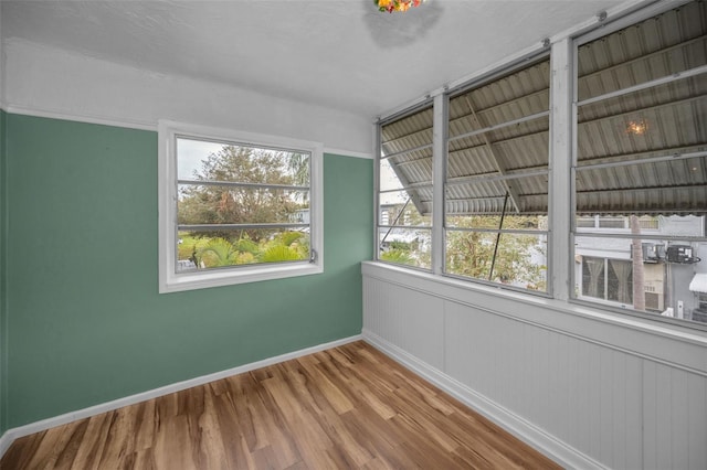 spare room featuring wood-type flooring