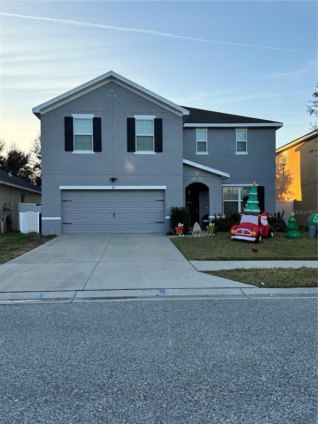 451 Hartford Heights St, Spring Hill, FL 34609 - traditional home with a garage, stucco siding, and driveway