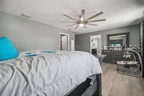 bedroom with ceiling fan and light wood-type flooring