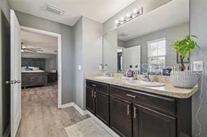 bathroom featuring hardwood / wood-style flooring, vanity, and ceiling fan