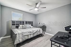 bedroom featuring ceiling fan and hardwood / wood-style flooring