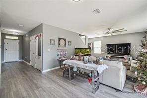 living room featuring ceiling fan and wood-type flooring