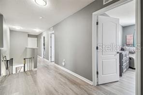 hall with light hardwood / wood-style flooring