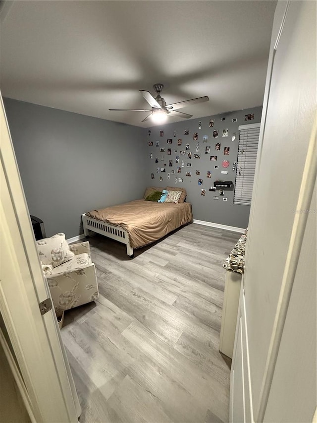 bedroom with ceiling fan and light hardwood / wood-style flooring