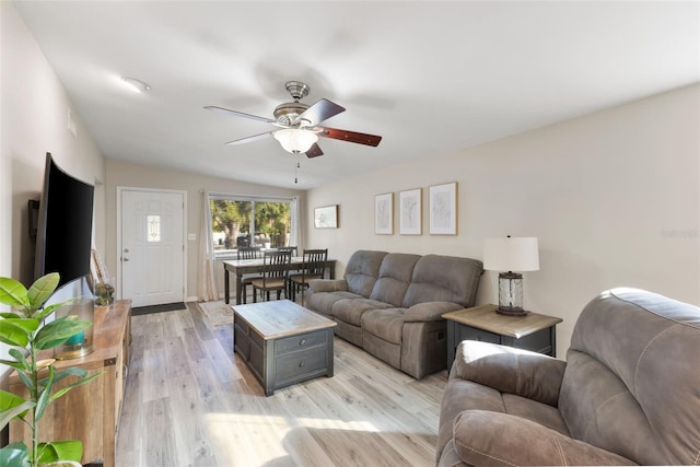 living room with light wood-type flooring, ceiling fan, and lofted ceiling