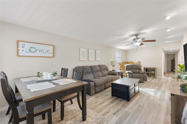 living room featuring light wood-type flooring and ceiling fan